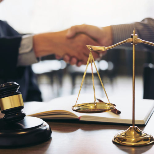 Handshake after good cooperation, Consultation between a male lawyer and businessman customer, tax and the company of real estate concept Handshake after good cooperation, Consultation between a male lawyer and businessman customer, tax and the company of real estate concept.